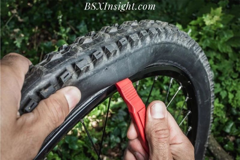 Unhook The Tire From The Wheel With Tire Levers